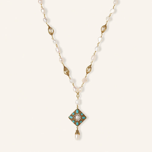 Y-shaped necklace with freshwater pearls, gold filigree stations, and ornate diamond-shaped centerpiece with pearl drop
