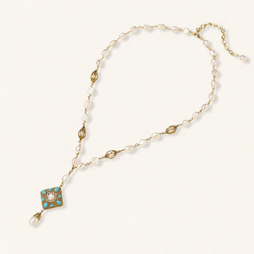 Y-shaped necklace with freshwater pearls, gold filigree stations, and ornate diamond-shaped centerpiece with pearl drop