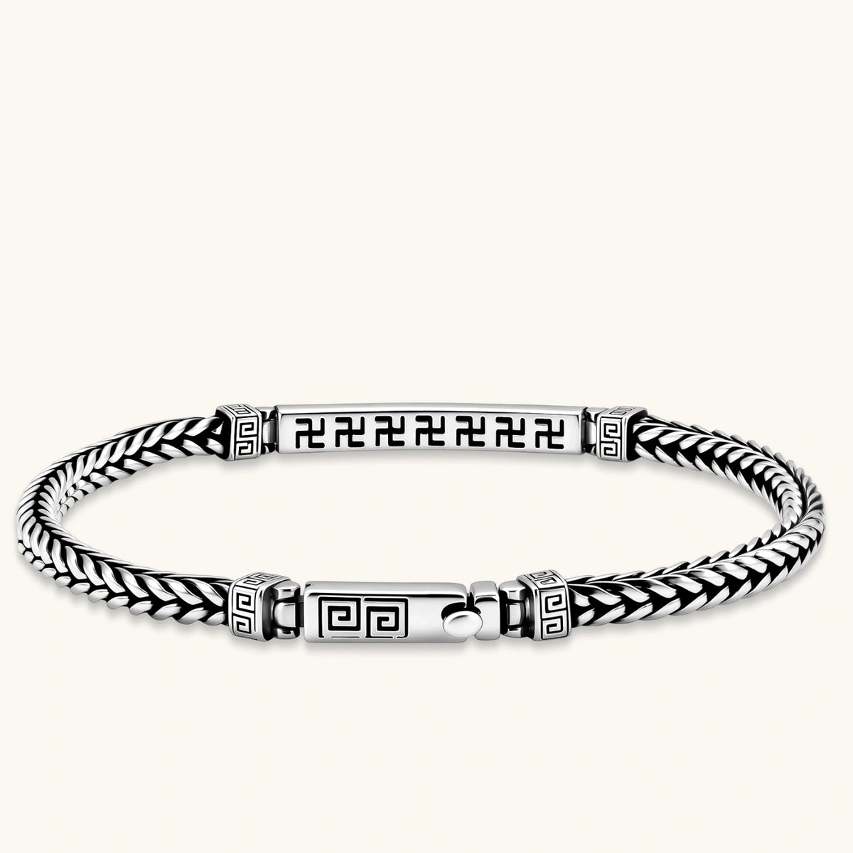 Silver stainless steel men's bracelet with braided foxtail chain, Greek key engraved bar, and decorative cube connectors.